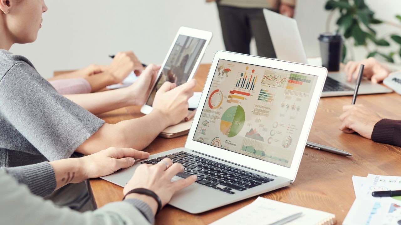 Team analyzing data on laptops for an AI agent and RAG workflow
