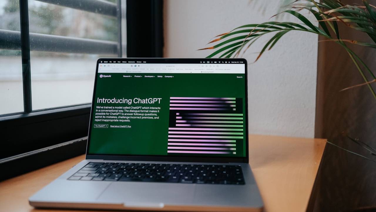 Laptop displaying an AI assistant in a bright workspace for AI search optimization