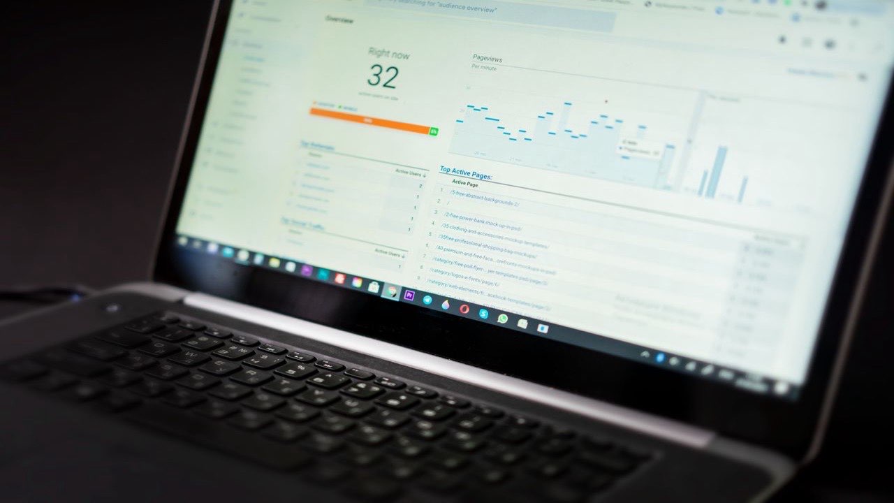 Laptop displaying an analytics dashboard with SEO audit data and charts