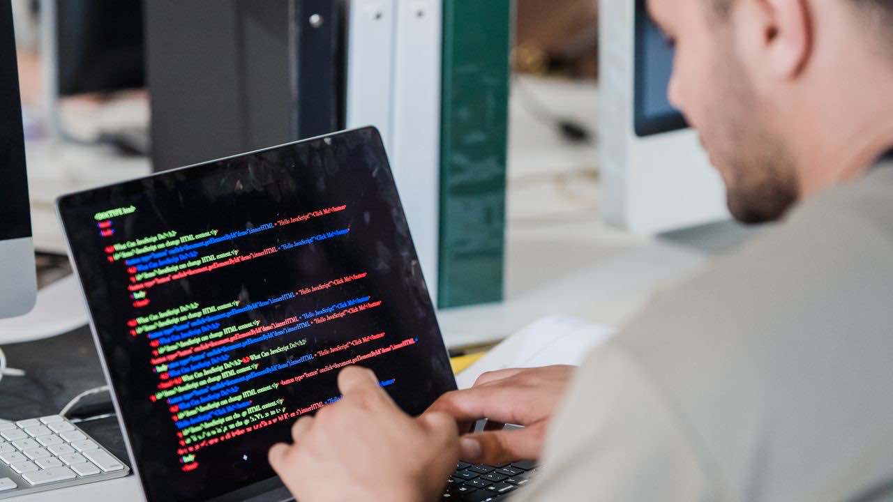 Software developer building a web scraping API workflow in a modern office